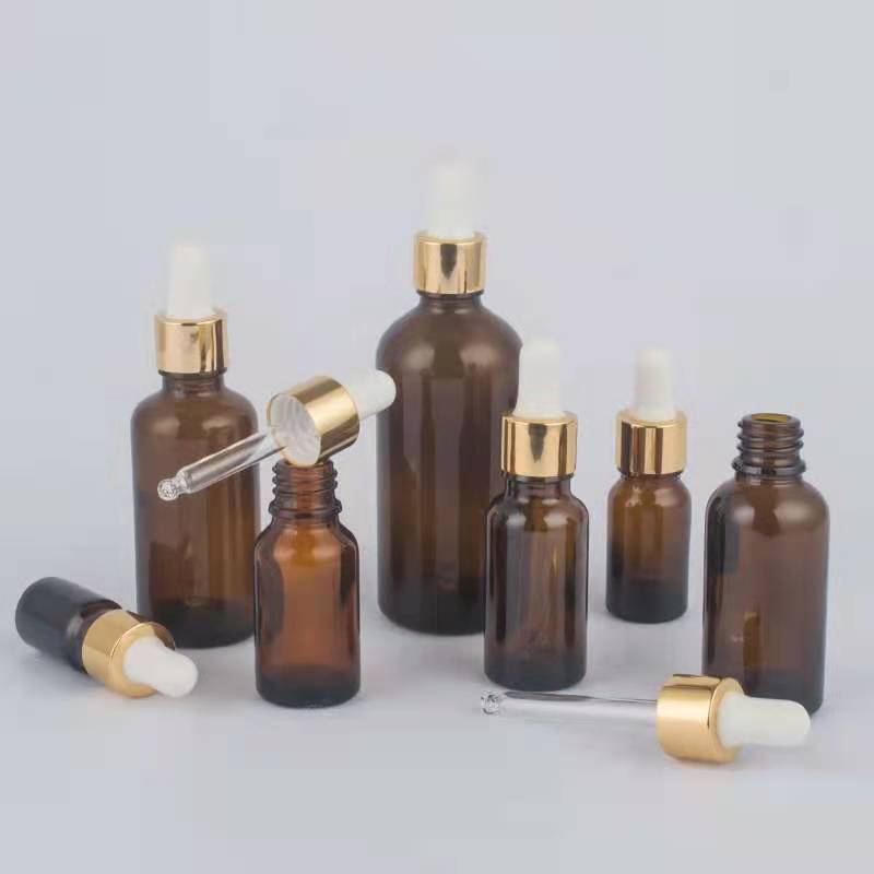 Amber glass bottle with alumite lid for cosmetic packaging 